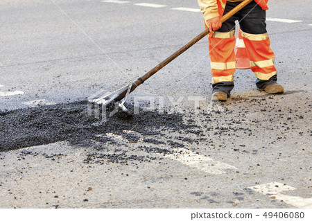 A road builder collects fresh asphalt on part 49406080