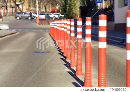 The roadway is divided by red road columns The roadway is divided by red road columns 49406081