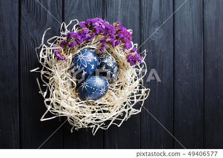 Hand painted dark blue easter eggs in nest and 49406577