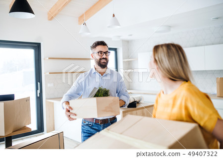 A young couple moving in new home. A young couple moving in new home. 49407322