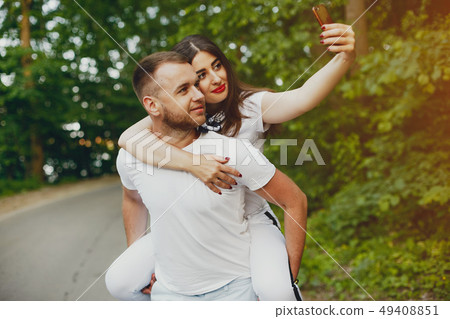Beautiful couple spend time in a summer park 49408851