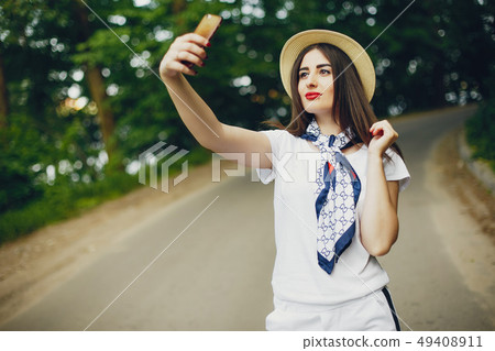 Cute girl walking in a summer park Cute girl walking in a summer park 49408911