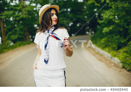 Cute girl walking in a summer park Cute girl walking in a summer park 49408940