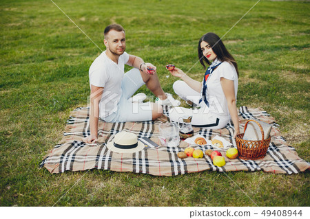 Beautiful couple spend time in a summer park 49408944