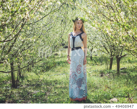 Young beautiful dreaming woman in spring blossom Young beautiful dreaming woman in spring blossom 49408947