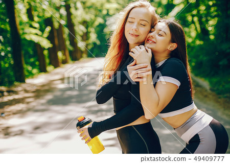 Sports girls in a park Sports girls in a park 49409777