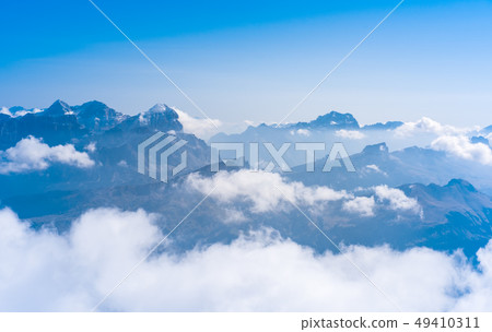 Silhouettes of the mountain in clouds Silhouettes of the mountain in clouds 49410311