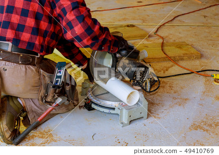 A plumber cut PVC pipe sawing pliers tool plumbing A plumber cut PVC pipe sawing pliers tool plumbing 49410769