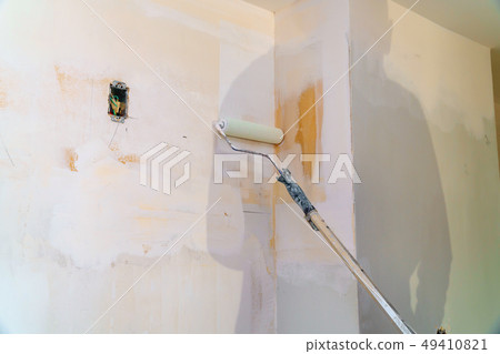 Painting walls, industrial worker using roller Painting walls, industrial worker using roller 49410821