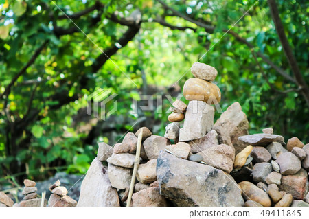 rock is arranged as a pagoda for worship of lord 49411845