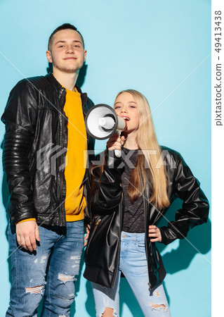 Portrait of young emotional female student with megaphone Portrait of young emotional female student with megaphone 49413438
