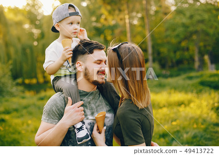Cute family in a park Cute family in a park 49413722