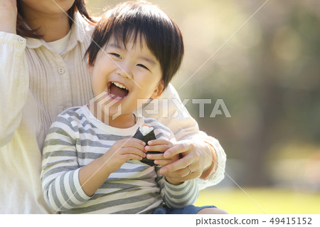 Boy eating rice balls Boy eating rice balls 49415152