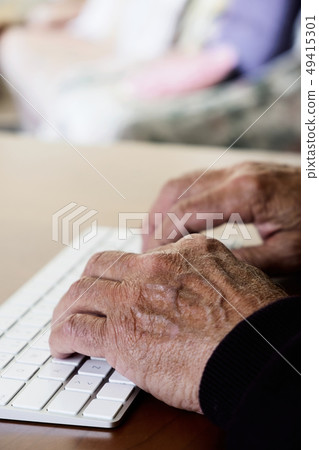old caucasian man typing in a keyboard old caucasian man typing in a keyboard 49415301
