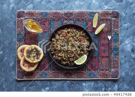 Indian minced meat Qeema on a dark background. Indian minced meat Qeema on a dark background. 49417486