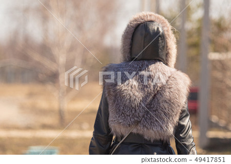 Leather jacket with fur on a girl in nature Leather jacket with fur on a girl in nature 49417851