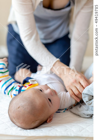 Baby changing clothes 49419785