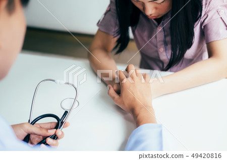 Patient in the doctor office receiving bad news. Patient in the doctor office receiving bad news. 49420816