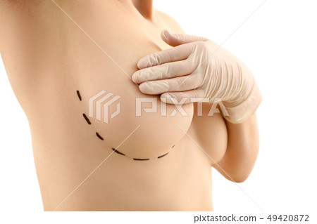 Female hand in gloves holding breast closeup 49420872