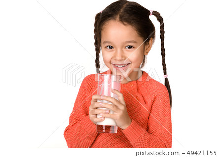 little child girl holding glass of milk on white background 49421155