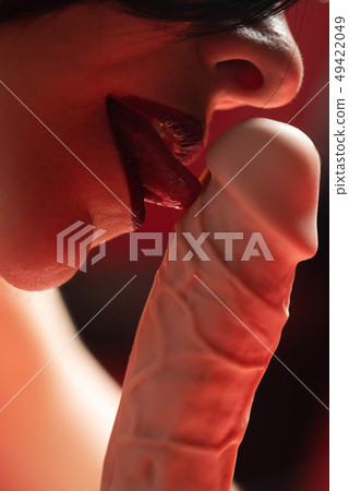 Close-up of female mouth with rubber dildo 49422049