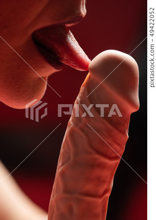 Woman with rubber dildo in red light 49422052