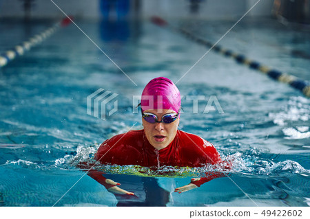 Female athlete in a red-yellow swimsuit 49422602