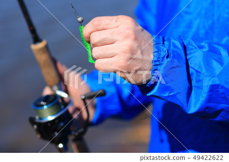 Fisherman holds spinning Fisherman holds spinning 49422622