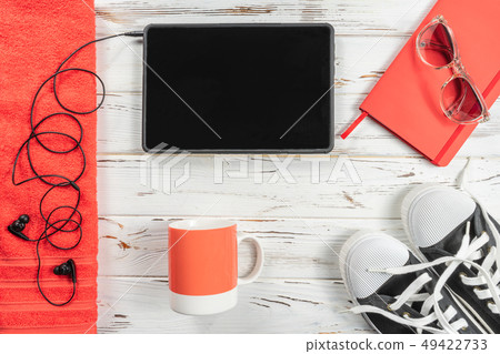 Fashion Weekly Planner, mug, towel, snickers, modern headphones and tablet on white rustic wood Fashion Weekly Planner, mug, towel, snickers, modern headphones and tablet on white rustic wood 49422733