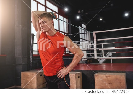 Stretch for success. Young muscular athlete in sports clothing stretching with expander before 49422904