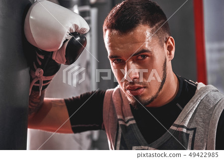 Tired after workout. Tired young athlete in sports clothing looking away after hard training on 49422985