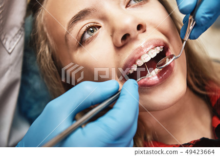 We can help you be at your best. Teen at the dental office. Dentist examining girl's teeth in clinic 49423664