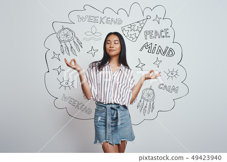 Zen-like. Close up portrait of young asian woman in casual wear meditating and keeping eyes closed 49423940