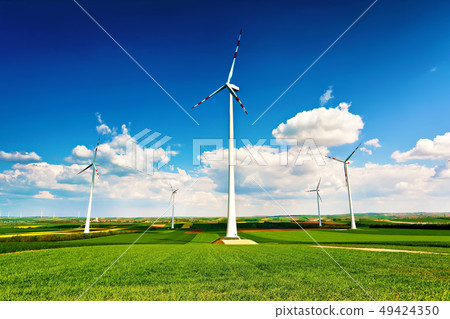 Spring sunny day, green fields. Wind turbines 49424350
