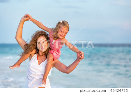 Happy mother and daughter on the ocean beach on Maldives at summer vacation 49424725