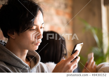 Couple lifestyle looking at smartphone 49430152