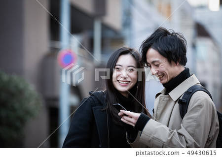 Couple lifestyle walking with smartphone 49430615