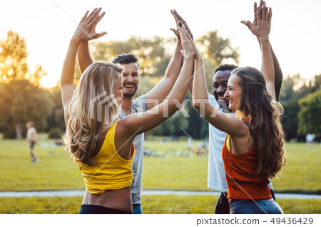 Friends having fun in the park enjoying themselves 49436429