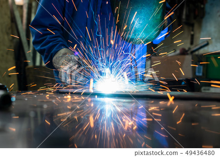 Welder in his workshop welding metal 49436480