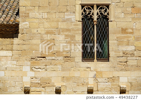 Background with antique window over strong stone wall 49438227