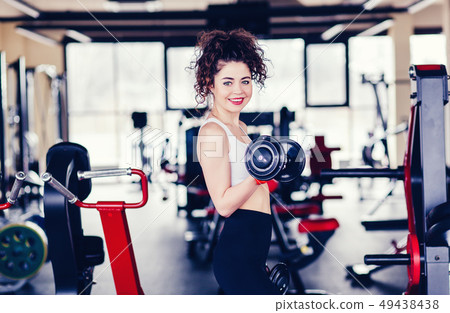 woman making exercise with dumbbells 49438438