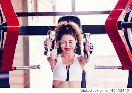 Athletic woman doing exercise for arms Athletic woman doing exercise for arms 49438440