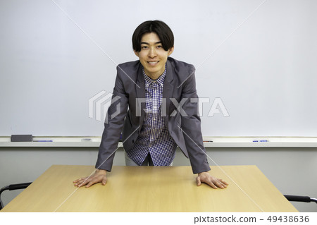 Young project manager giving positive words and morals in front of whiteboard 49438636