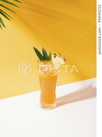 iced pineapple punch cocktail in glass iced pineapple punch cocktail in glass 49440252