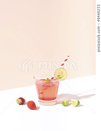 iced strawberry punch cocktail in glass with lime iced strawberry punch cocktail in glass with lime 49440255