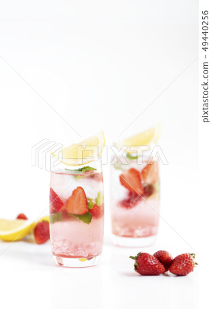 iced strawberry punch cocktail in glass with lemon iced strawberry punch cocktail in glass with lemon 49440256
