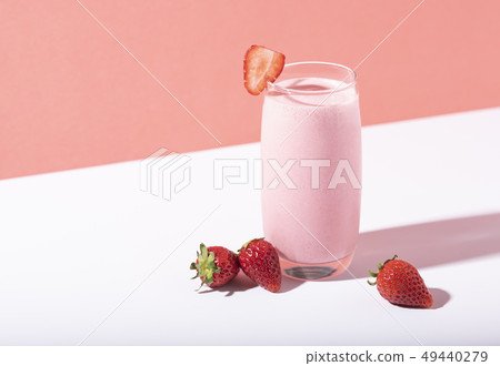 Strawberry smoothie in glass with straw Strawberry smoothie in glass with straw 49440279
