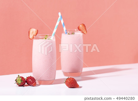 Strawberry smoothie in glass with straw Strawberry smoothie in glass with straw 49440280