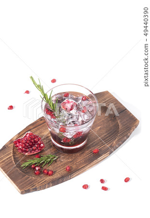 Pomegranate juice with ripe pomegranate on white 49440390