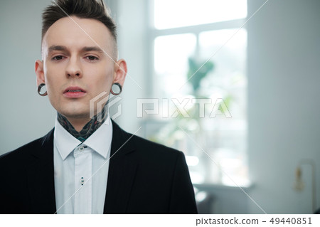 Portrait of alternative model with earplugs and tattoo 49440851